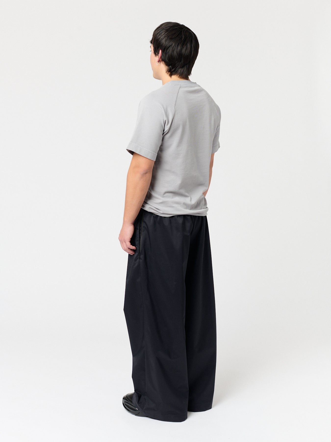rest defense stud draped trousers in raven black