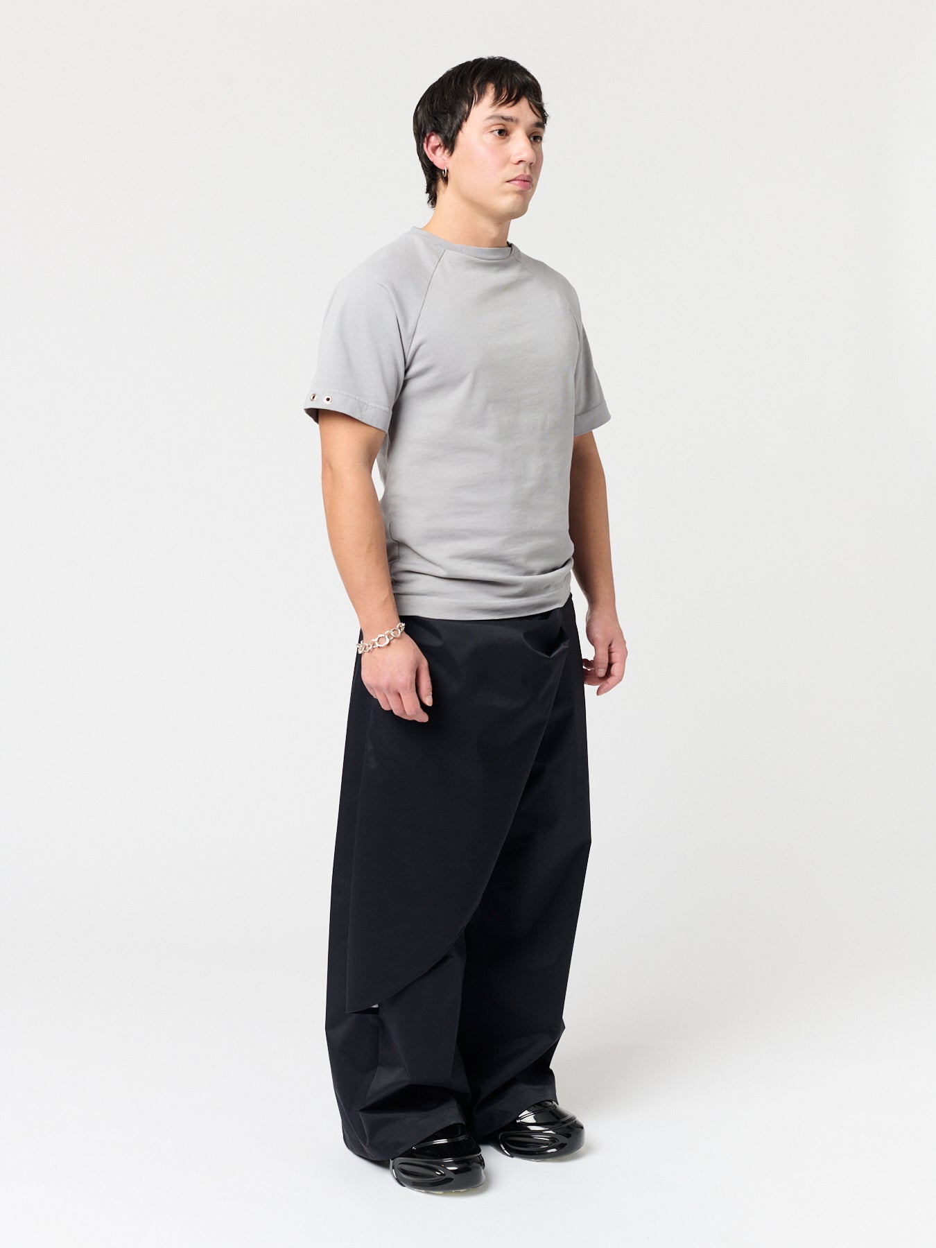 rest defense stud draped trousers in raven black